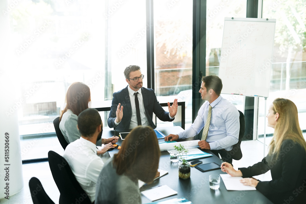 Working through the meeting agenda like pros. Shot of a team of executives having a formal meeting in a boardroom. Working through the meeting agenda like pros. Shot of a team of executives having a formal meeting in a boardroom.