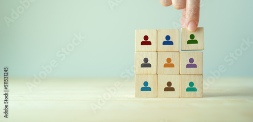 Team building and diversity concept. Work collaboration for achieving goal and successful business. Productive people skills. Hand placed wooden cubes with team diversity building icons. HRM Banner. photo