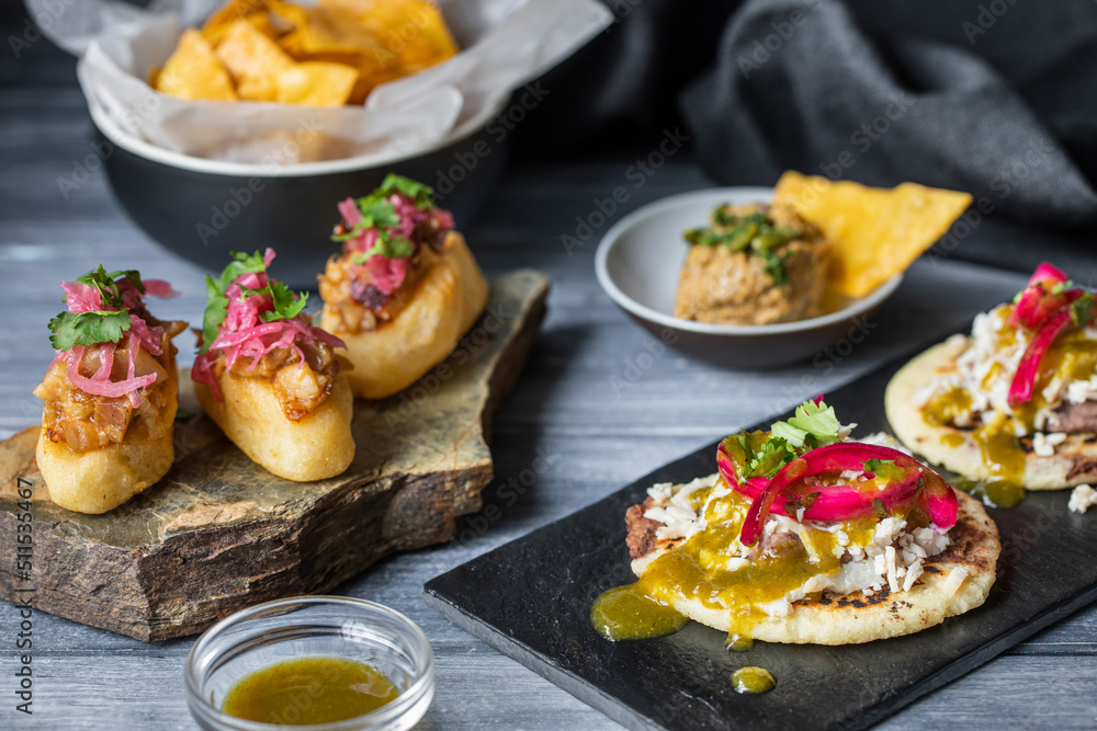 Yummy polkanes and Yucatan panuchos served on stone Yummy polkanes and Yucatan panuchos served on stone