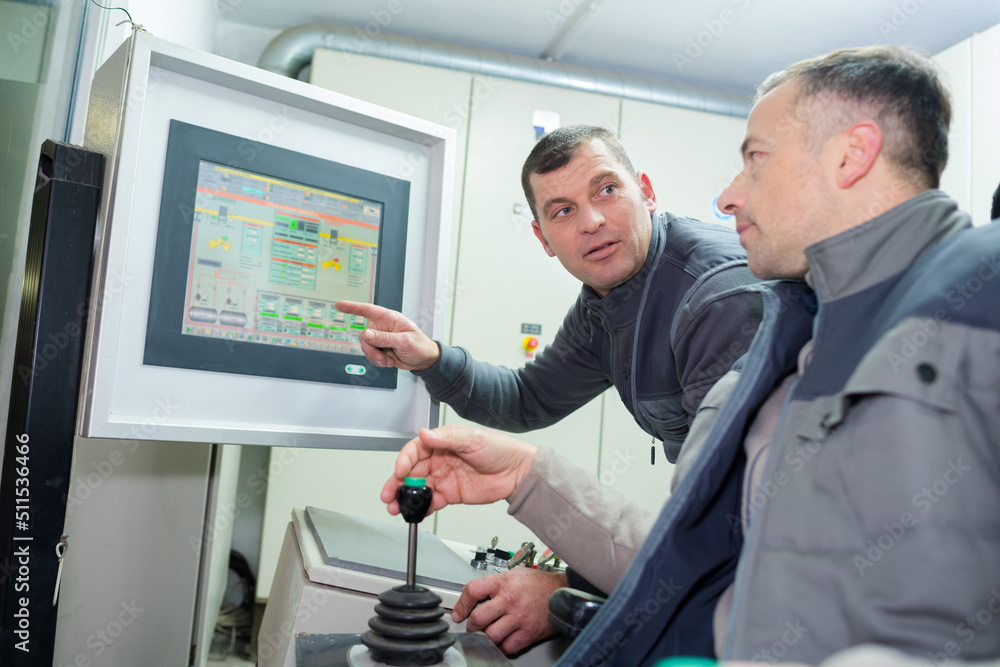 industrial colleagues consulting computer monitor