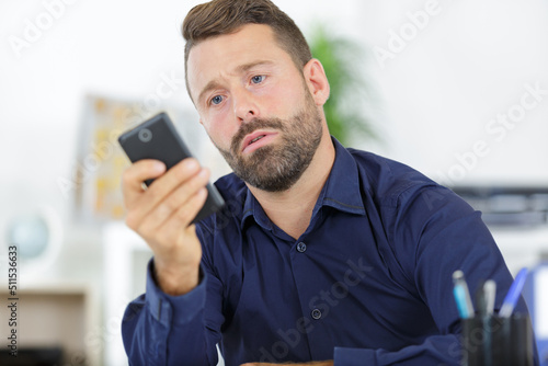 young office worker reading text message