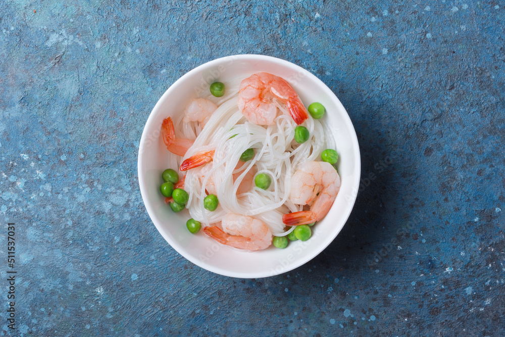 A traditional dish of Asian cuisine. Rice vermicelli with shrimps and green peas A traditional dish of Asian cuisine. Rice vermicelli with shrimps and green peas