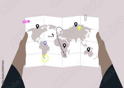 Hands holding a global map with folding lines and geo pins, travel concept