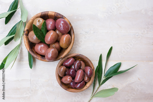 Wooden bowls of delicious olives photo