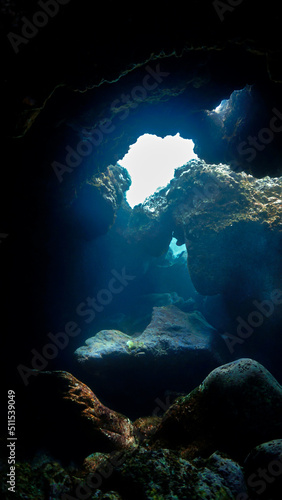 Underwater photo of magic sunlight inside a cave.