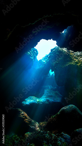Underwater photo of magic sunlight inside a cave.