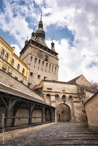 Cityscape of street with Clock Tower in old town Sighisoara, Romania