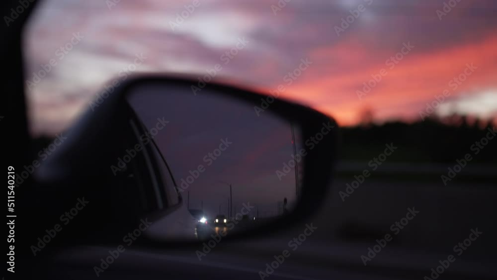 Reflection of other vehicles in a passenger side mirror, during a beautiful golden hour sunset. Slow motion. Reflection of other vehicles in a passenger side mirror, during a beautiful golden hour sunset. Slow motion.