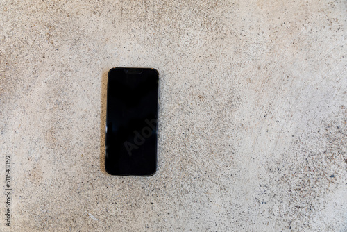 smartphone with black screen on the old cement floor © kowitstockphoto
