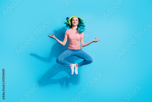 Photo of pretty female doing yoga poses in air practice peaceful harmony thoughts isolated on blue color background