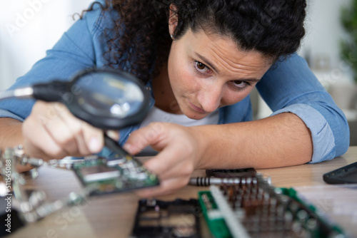 Wallpaper Mural woman using a magnifying glass Torontodigital.ca
