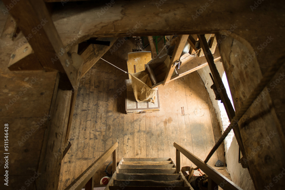 Fototapeta premium View from the attic of a flour mill, one level lower, where the flour, at the end of the grinding process, is collected in a flour bag. This scaffolding mill was built in 1960 in Oss (Netherlands).