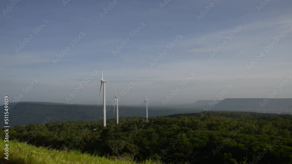 Windmills turn the wind in the middle of mountains, forests and fields. Windmills turn the wind in the middle of mountains, forests and fields.