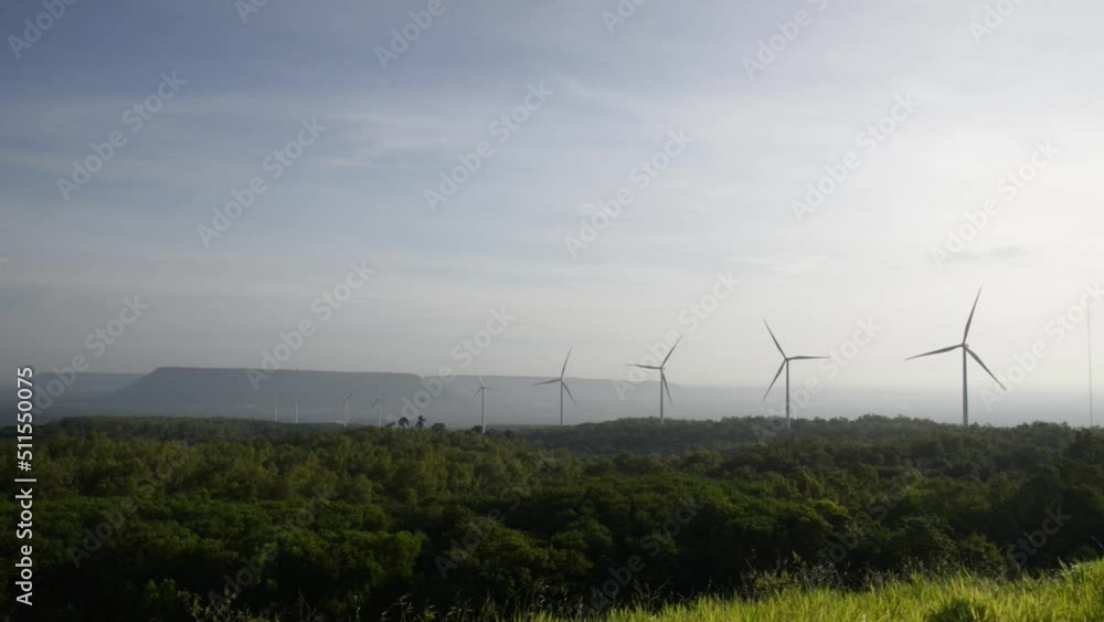 Windmills turn the wind in the middle of mountains, forests and fields. Windmills turn the wind in the middle of mountains, forests and fields.