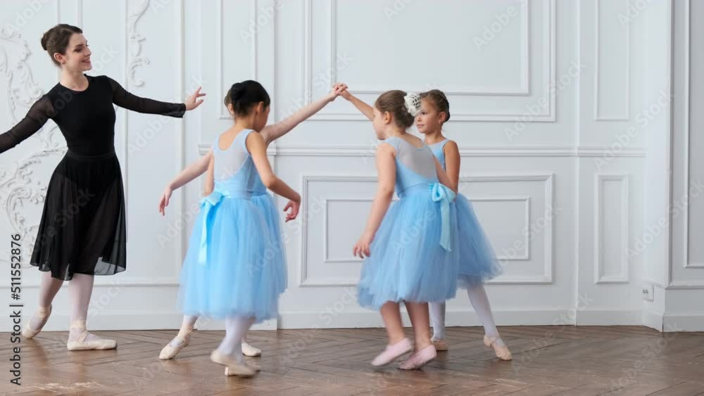 Young girls from ballet dancing ballet in white studio. Pretty graceful ballerinas doing elements of classical ballet - arts concept 4k footage Young girls from ballet dancing ballet in white studio. Pretty graceful ballerinas doing elements of classical ballet - arts concept 4k footage
