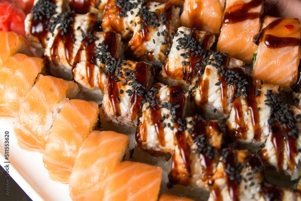 Japanese food restaurant, salmon sushi maki gunkan roll plate or platter set. Set for two with chopsticks, ginger, soy, wasabi. Japanese food restaurant, salmon sushi maki gunkan roll plate or platter set. Set for two with chopsticks, ginger, soy, wasabi.