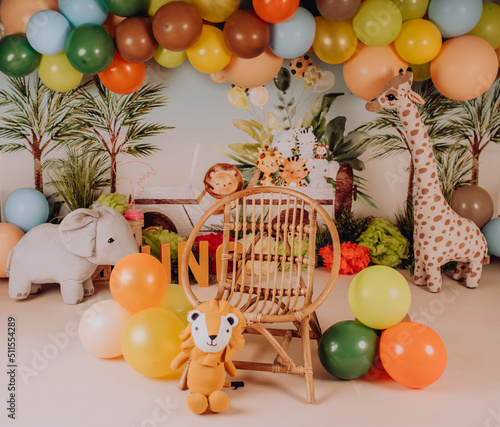 first year birthday photo session in a photo studio with a jungle backdrop and decor photo