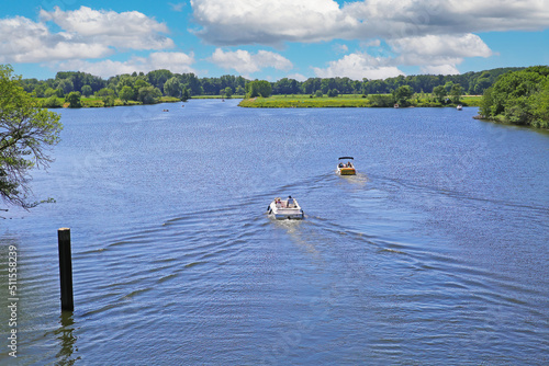 Beautiful idyllic dutch lakescape  2 motor sport boats  green forest   blue summer sky - Leukermeer  Netherlands