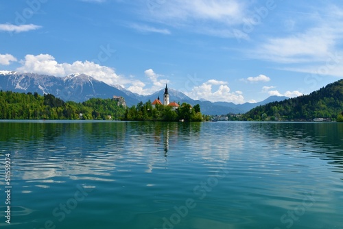 View of the church on an island on lake Bled in Gorenjska, Slovenia with mountains behind