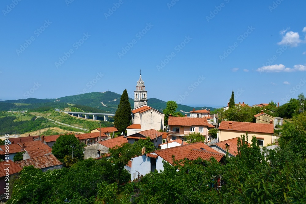 View of Crni Kal village with an old church of St. Valentin in Primorska, Slovenia and the viaduct