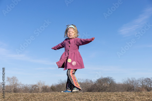 Vászonkép Hippie girl twirling on a hilltop in the springtime