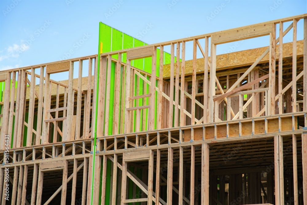 Obraz premium New apartment building under construction on sunny day plywood frame facade