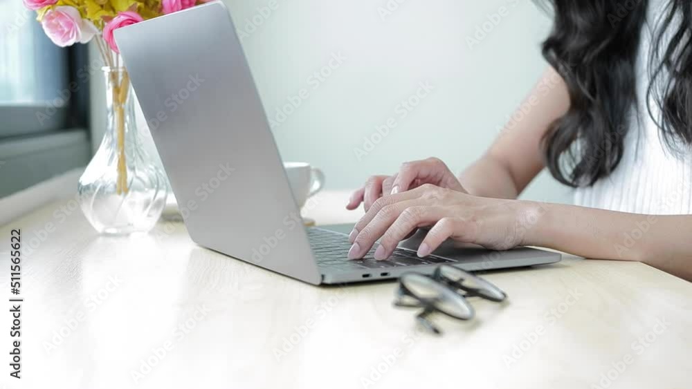 Close up view female hands typing on laptop, doing online job, emailing to client while sitting at office desk Close up view female hands typing on laptop, doing online job, emailing to client while sitting at office desk