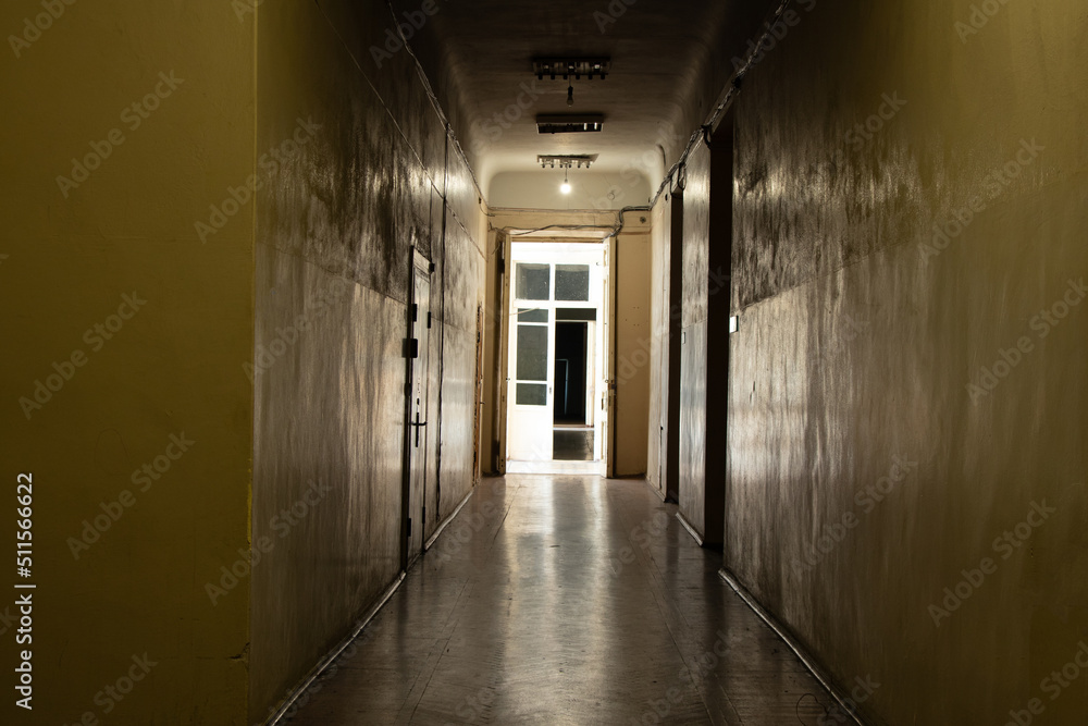 An old dark corridor is long in an office building in the city center in Ukraine, a door to the corridor, an exit, a building