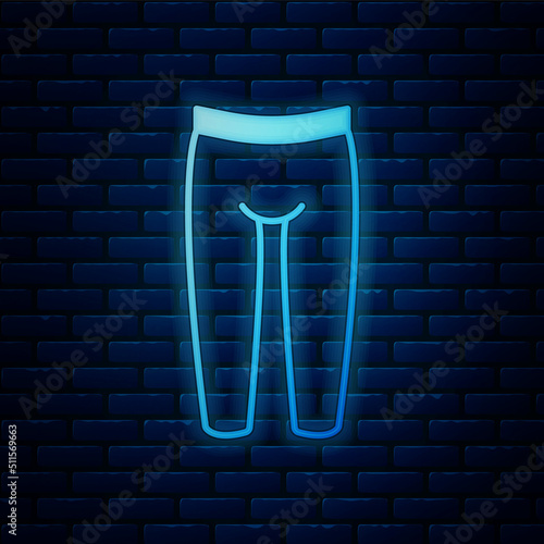Glowing neon Leggings icon isolated on brick wall background. Vector