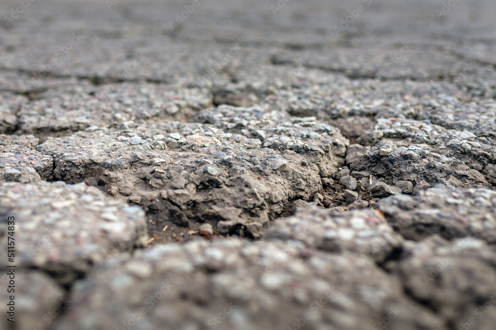 Empty damaged alphalt road in the street.Blurred foreground and background.Closeup.Selective focus. Empty damaged alphalt road in the street.Blurred foreground and background.Closeup.Selective focus.