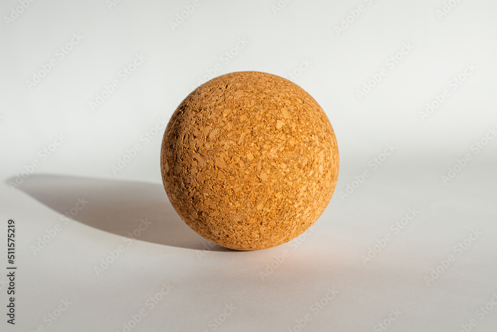 Nice brown cork ball lie on the white gray background.Copy space. Nice brown cork ball lie on the white gray background.Copy space.