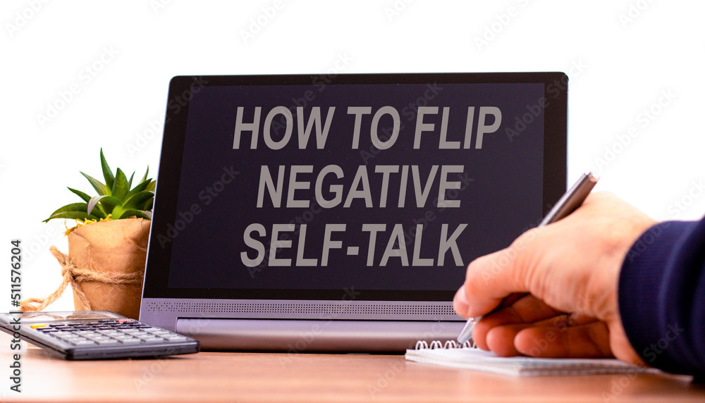 Flip negative self-talk symbol. Concept words How to flip negative self-talk on the black tablet. Businessman hand with pen. Psychological and flip negative self-talk concept. Copy space. Flip negative self-talk symbol. Concept words How to flip negative self-talk on the black tablet. Businessman hand with pen. Psychological and flip negative self-talk concept. Copy space.