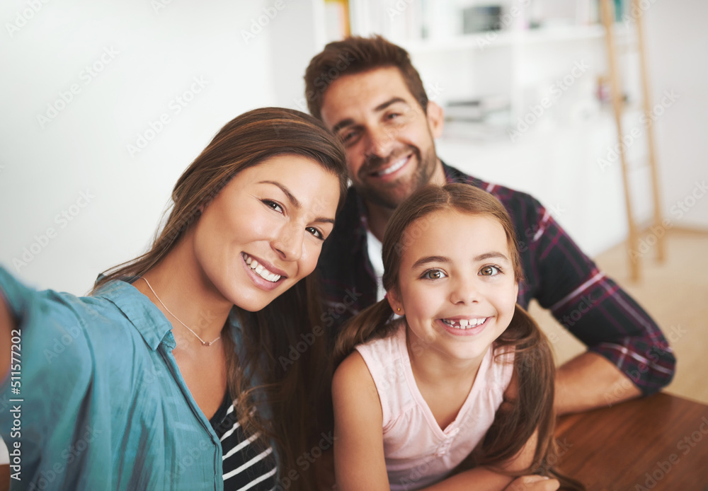 This family isnt selfie shy. Portrait of a happy married couple and their young daughter posing for a selfie together at home. This family isnt selfie shy. Portrait of a happy married couple and their young daughter posing for a selfie together at home.