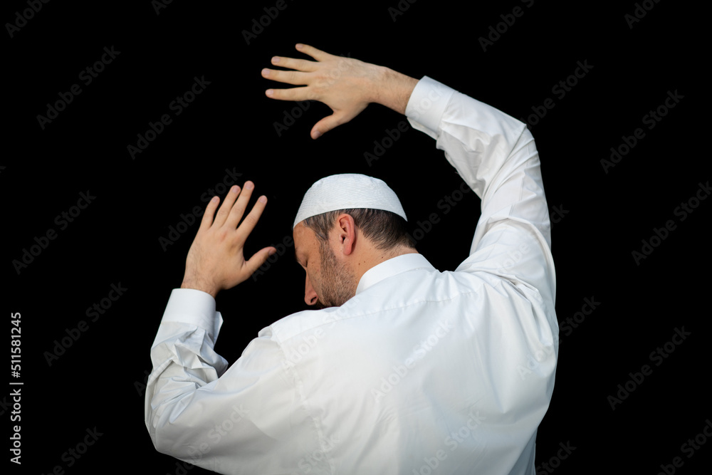 Naklejka premium Muslim man standing and praying in the front of Kaaba in Mecca, KSA