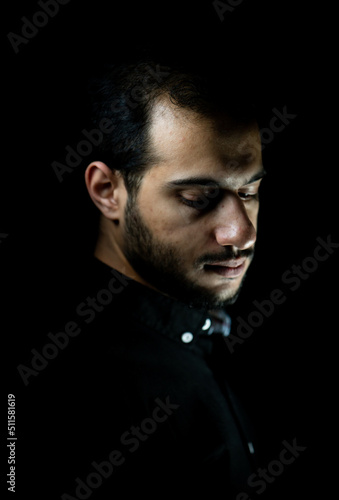 Portrait of young attractive man on a black background. High quality photo