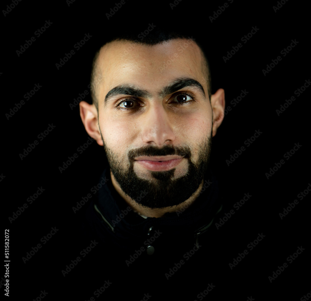 Fototapeta premium Portrait of young attractive man on a black background. High quality photo