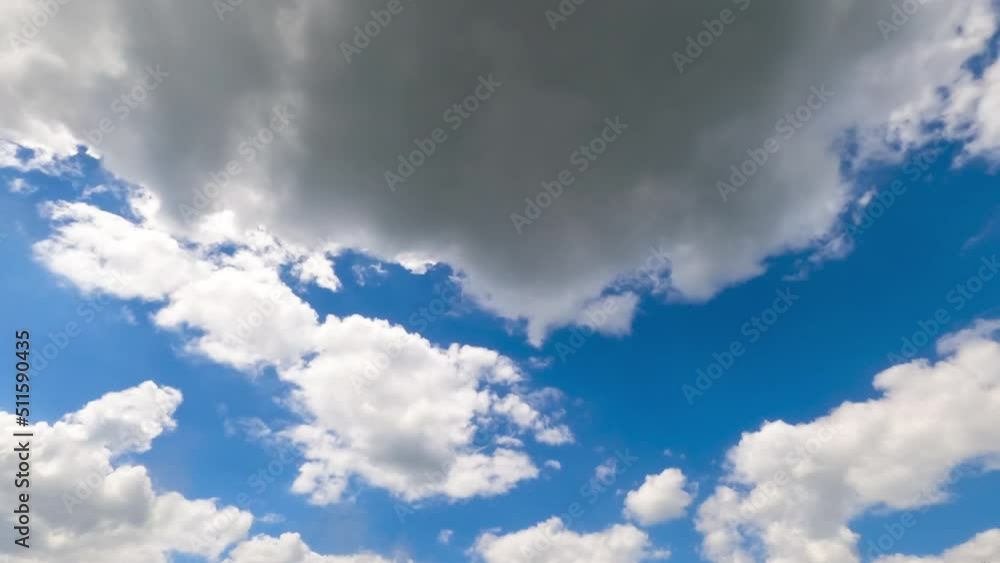 Sunlit shining white clouds in the blue skies. Sunny day footage. Low angle view. Timelapse. Sunlit shining white clouds in the blue skies. Sunny day footage. Low angle view. Timelapse.