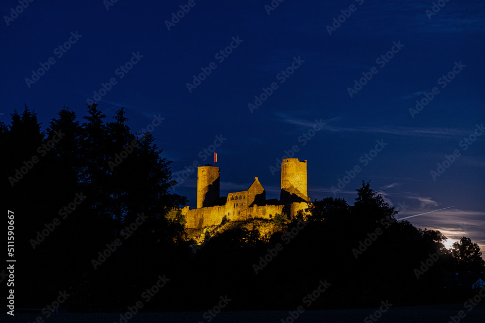 Obraz premium Image of illuminated Muenzenberg castle ruin in Germany in the evening