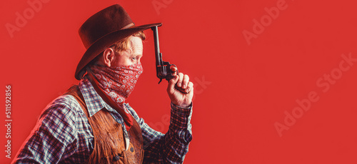 Portrait of cowboy in hat. Portrait of man wearing cowboy hat, gun. Portrait of a cowboy. West, guns