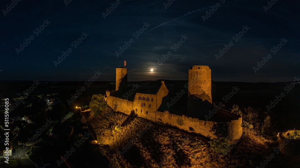Obraz premium Image of illuminated Muenzenberg castle ruin in Germany in the evening