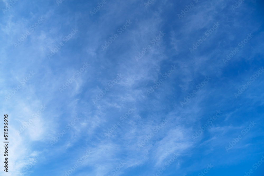 bright blue sky with clouds as abstract background