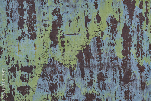 Background is sheet rusty and old metal with peeling green paint.