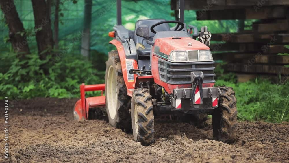A remote-controlled minitractor loosens the soil for the lawn. Land works. A remote-controlled minitractor loosens the soil for the lawn. Land works.