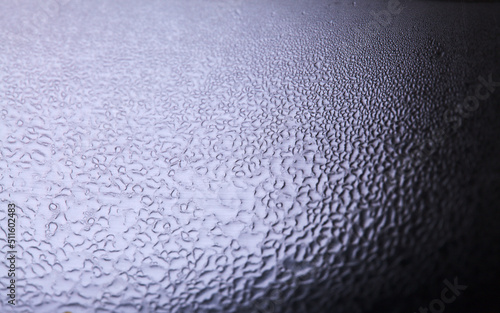Macro background with water droplets condensation pattern on metal surface 