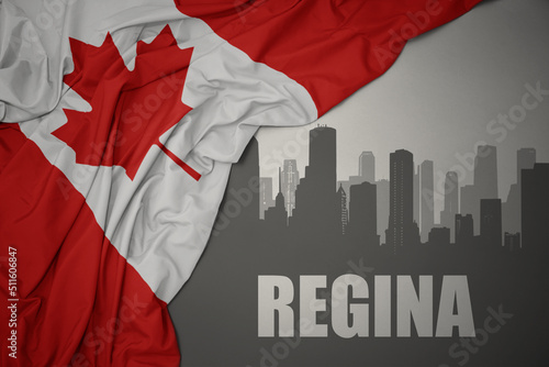 abstract silhouette of the city with text Regina near waving national flag of canada on a gray background.