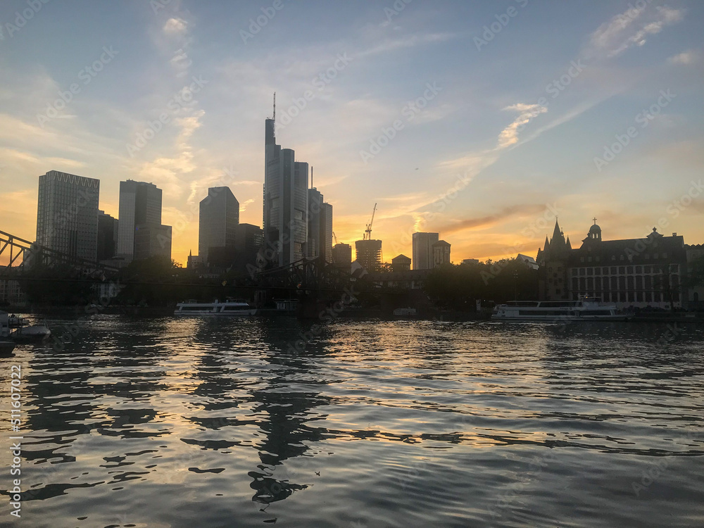 Obraz premium Frankfurt, Germany - May, 2022: city skyline - Sunset in River Main