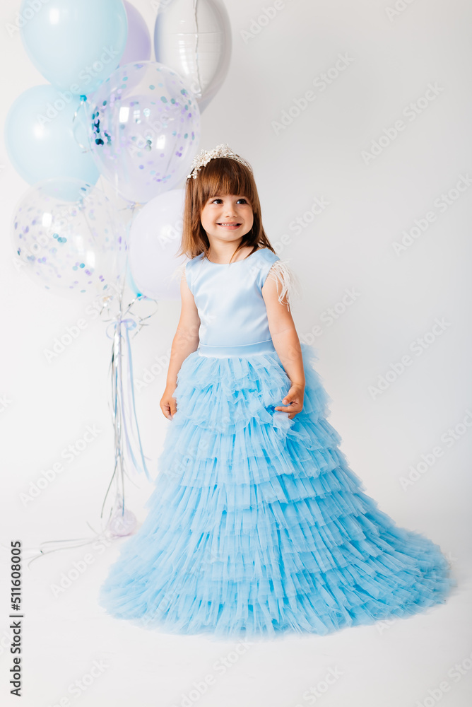 Little girl in a blue dress with balloons Little girl in a blue dress with balloons