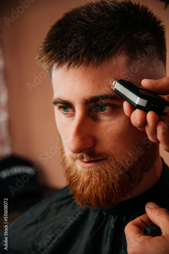 Shaving with wax in a barbershop with a shaver