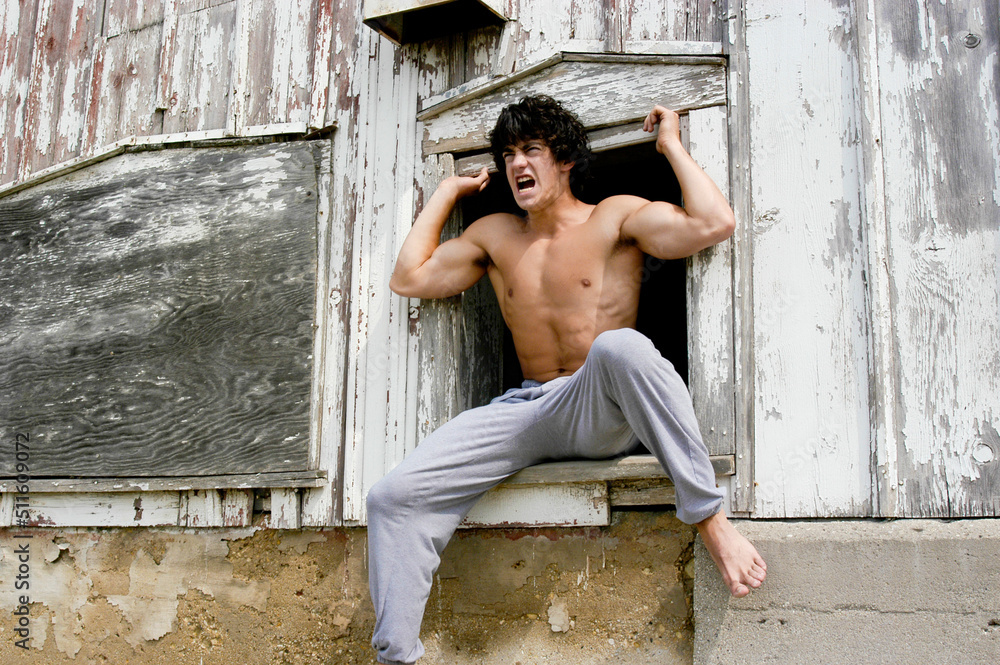 Guy Retching Young athletic male is angry while he is screaming and yelling from a ...