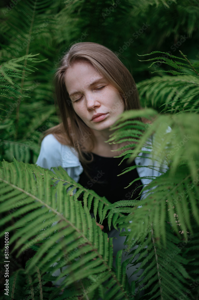 Girl in green forest. Practice of meditation and interaction with nature Girl in green forest. Practice of meditation and interaction with nature
